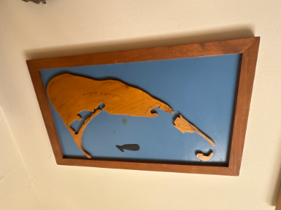 Vintage wooden Nantucket and whale map on a blue background